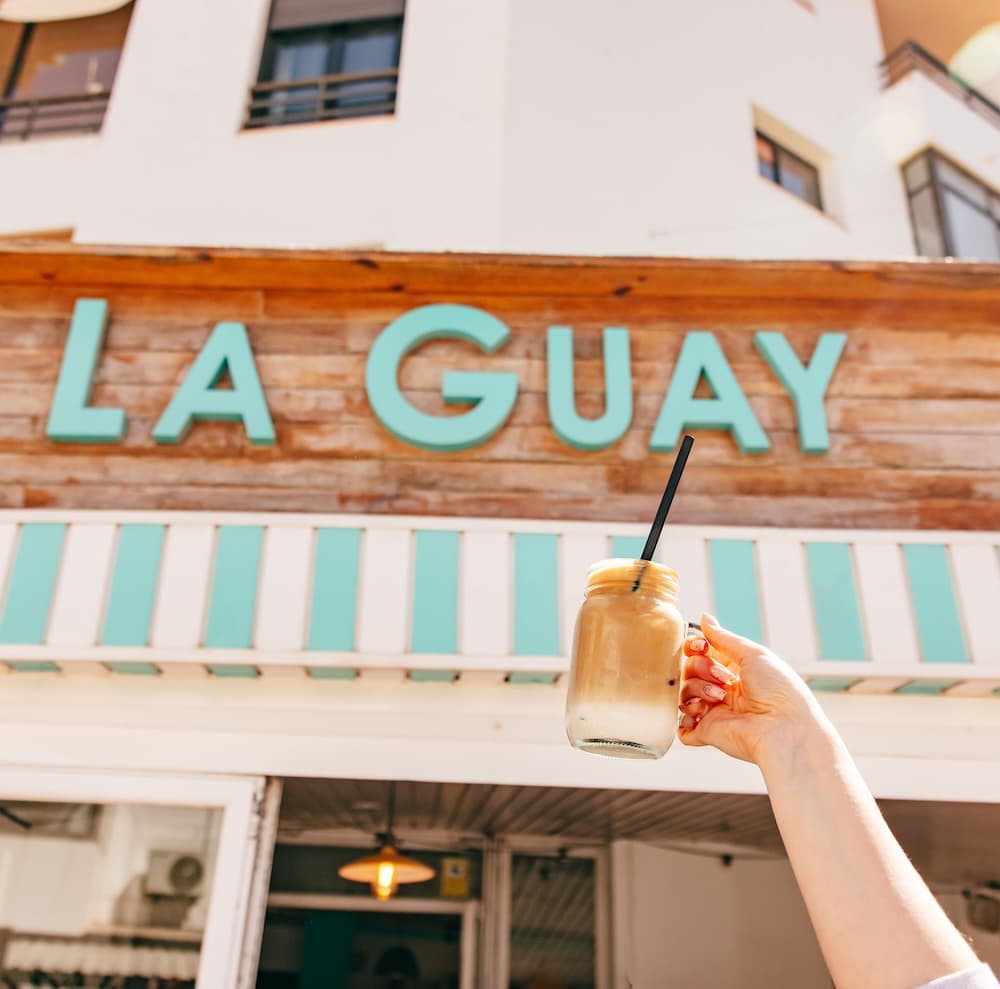 Iced drink raised outside the La Guay café frontage